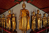 Bangkok Wat Pho, Buddha gilded statues lined in the double cloister enclosing the ubosot.  